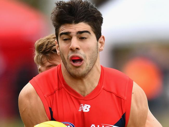 MELBOURNE, AUSTRALIA - FEBRUARY 18: Christian Petracca of the Demons handballs whilst being tackled during the 2017 JLT Community Series match between the Western Bulldogs and the Melbourne Demons at Whitten Oval on February 18, 2017 in Melbourne, Australia. (Photo by Quinn Rooney/Getty Images)