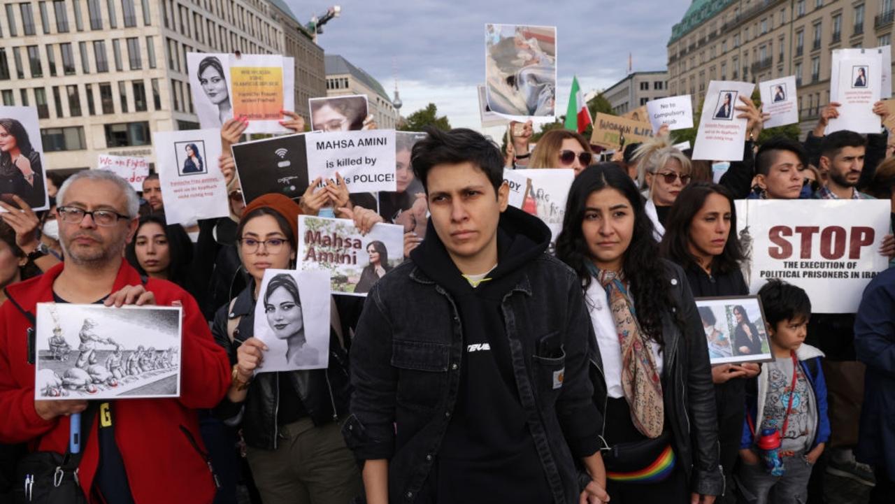 Protesters, including a lesbian couple holding hands, gather to demonstrate against the death of Mahsa Amini in Iran on September 23, 2022 in Berlin, Germany. She died after being arrested for not wearing a headscarf properly. Picture: Sean Gallup/Getty Images