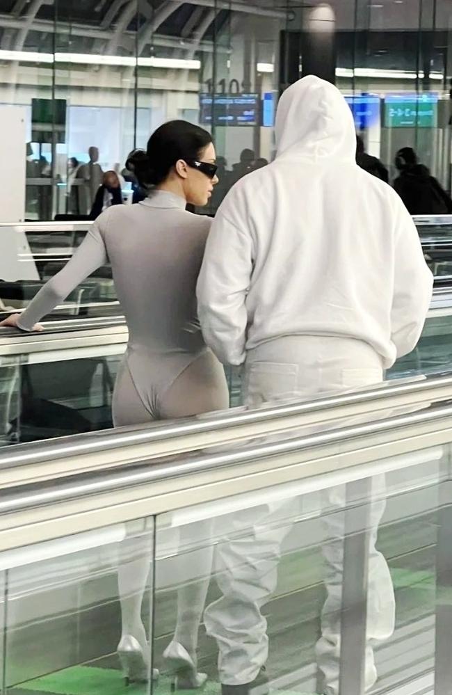 Kanye West and Bianca Censori make their way through Haneda Airport in Tokyo, with Censori wearing a white thong bodysuit. Picture: BACKGRID