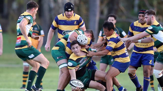 Gold Coast District Rugby Union match between Gold Coast Eagles and Surfers Paradise at James Overell Park. Surfers Paradise scrumhalf James Crisp offloads under pressure from Eagles player Shoma Okubo. Picture: Richard Gosling