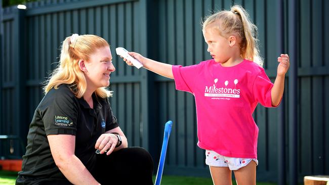 Milestones Early Learning The Lakes; Sophie McCarthy 5, takes Lead Educator Melissa Laundess temperature.