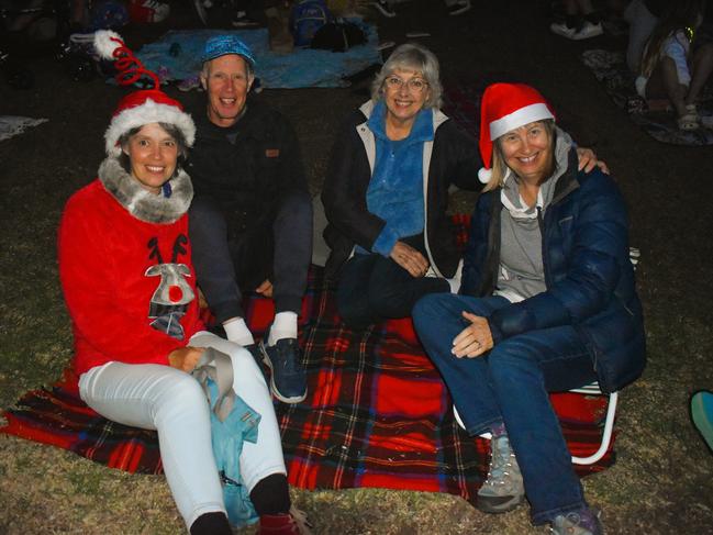 Becki Stuchbery, Danny Hunt, Sue Kmetko and Beth Hunt getting festive at the Phillip Island Christmas Carols by the Bay at the Cowes Foreshore on Tuesday, December 10, 2024. Picture: Jack Colantuono