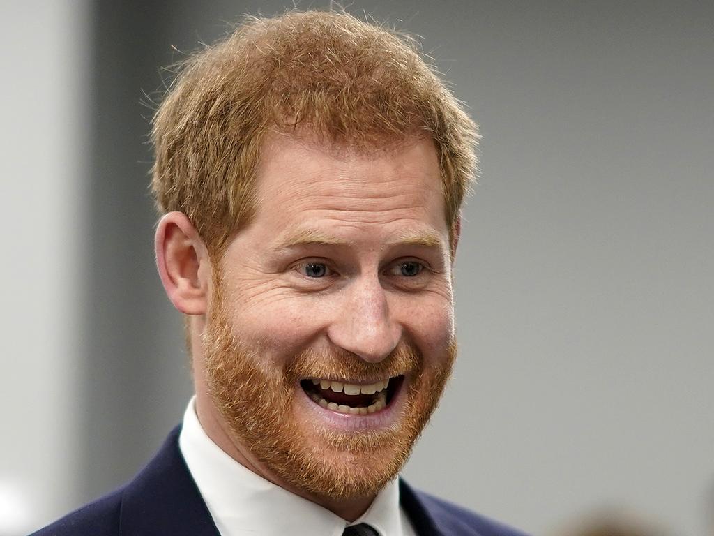 Prince Harry is all smiles alone or with pals. Picture: Getty Images