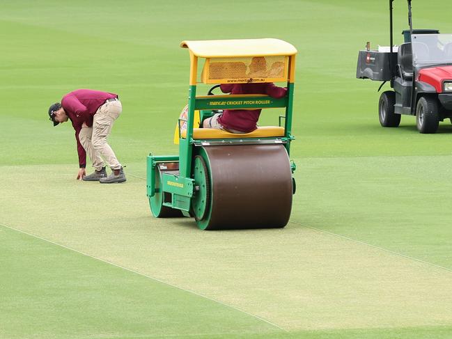 Staff work on the pitch at the Gabba ahead of the third test starting on Saturday. Picture: Adam Head