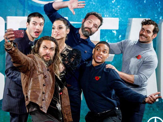 Ezra Miller, Jason Momoa, Gal Gadot, Ben Affleck, Ray Fisher and Henry Cavill pose for a selfie photograph at a photocall for the film Justice League in London. Picture: Tolga Akmen/AFP PHOTO