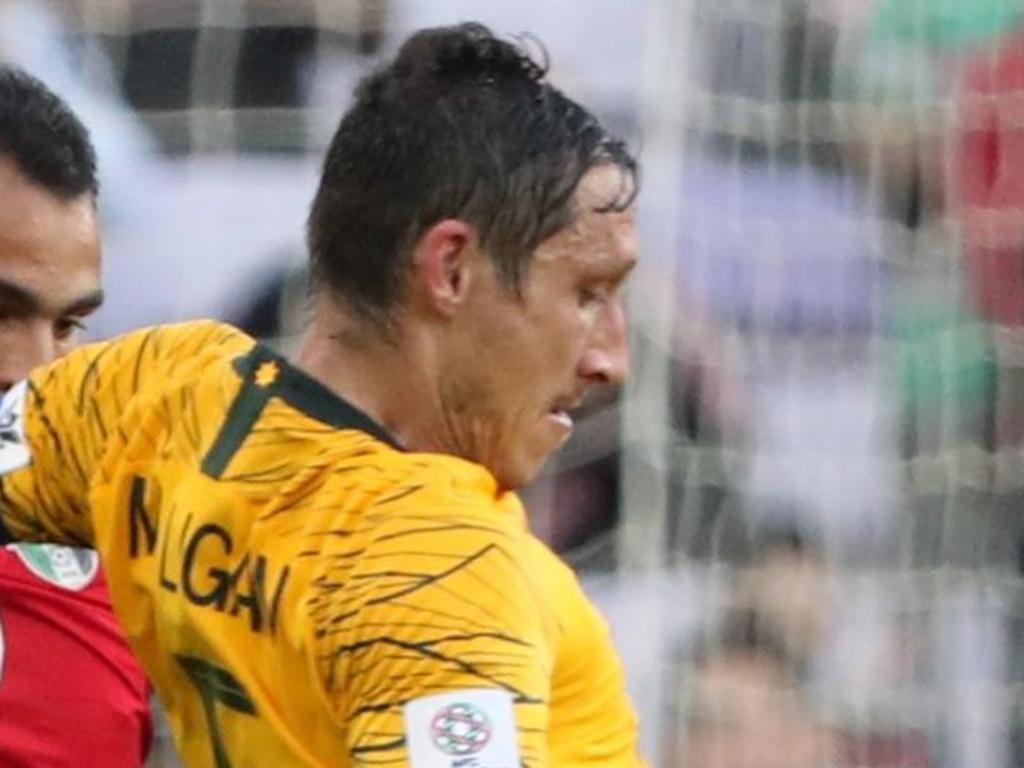 Australia's midfielder Mark Milligan (R) fights for the ball with Jordan's forward Baha Faisal during the 2019 AFC Asian Cup football game between Australia and Jordan at the Hazza Bin Zayed stadium in Al-Ain on January 6, 2019. (Photo by KARIM SAHIB / AFP)