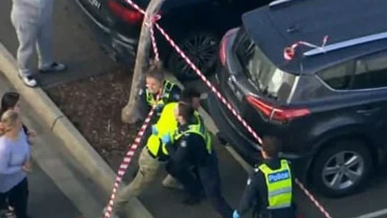 Police restrain a man at the scene. Courtesy: Nine News