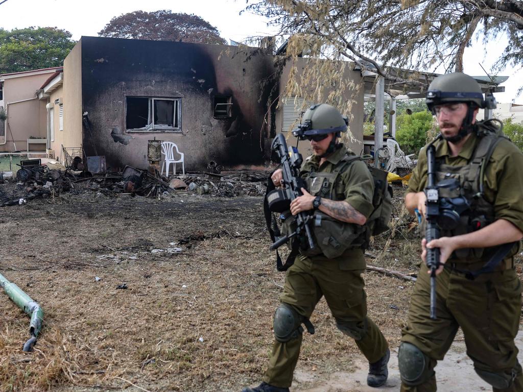 Israeli troops patrol inside kibbutz Kfar Aza on the border with the Gaza Strip, where at least 100 people were reported killed by Hamas militants last week. Picture: AFP