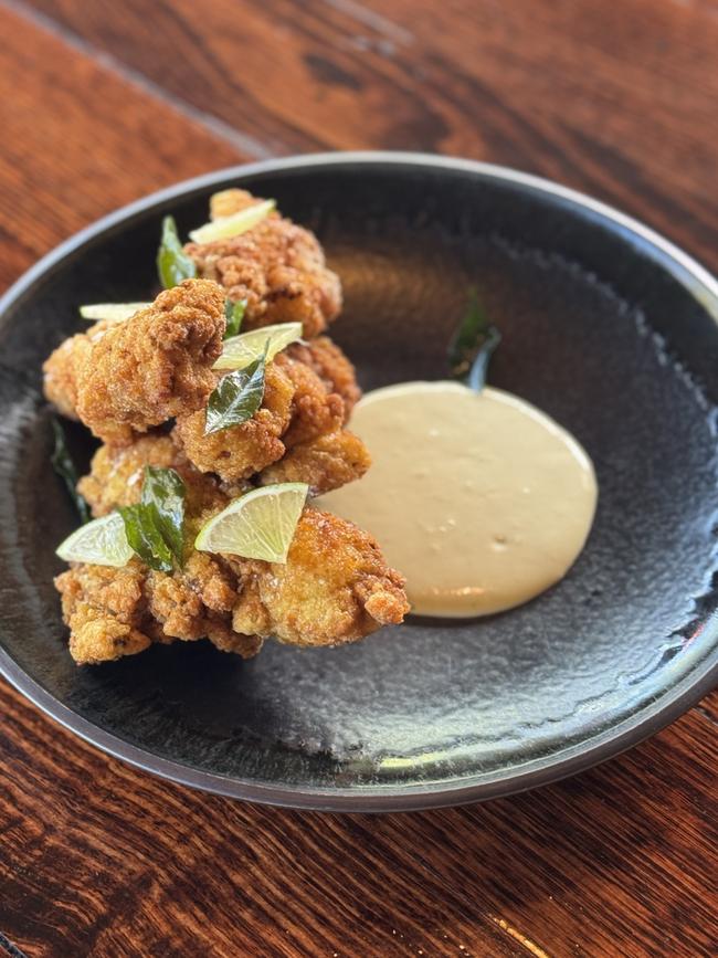 Lost in Asia's Ayam Goreng dish which features spiced fried chicken with jim jeaw mayo, crispy curry leaves. Picture: Supplied