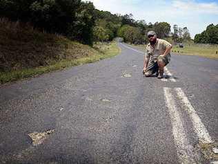 SORRY STATE: Peter Szaak of Booerie Creek is concerned about the condition of Nimbin Rd in front of his house, where there have been eight accidents in six months. Picture: Cathy Adams