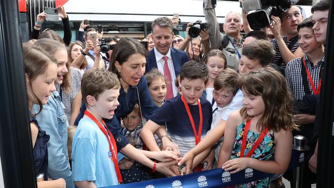 Children help Gladys Berejiklian and Andrew Constance to cut the ribbon before the light rail made its first trip to Randwick. Picture: Tim Hunter