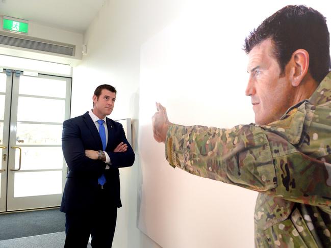 Corporal Ben Roberts-Smith VC examines a portrait of himself at the Australian War Memorial in Canberra. Picture: AAP