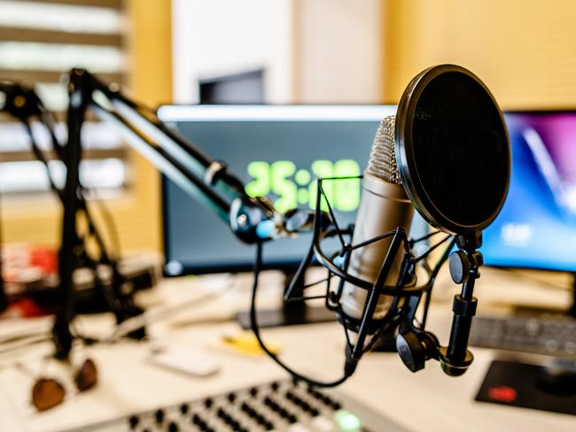 Microphone and mixer at the radio station studio broadcasting news. iStock