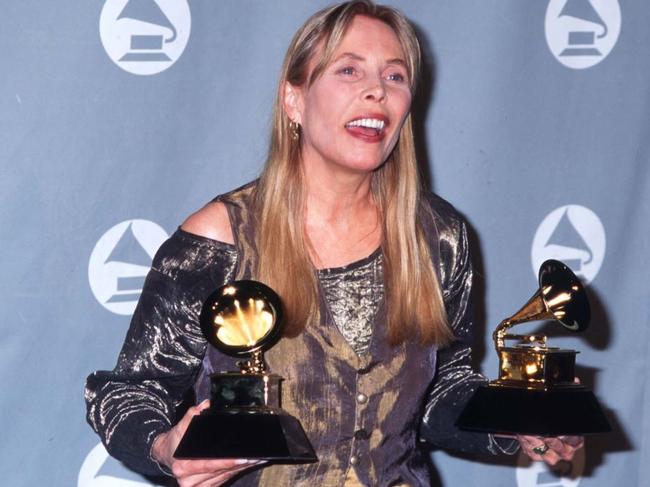 Mitchell holds her two Grammys after the 1996 award ceremony in Los Angeles. She won the best pop album and best recording package awards for "Turbulent Indigo." Russell Einhorn/Liaison/getty images