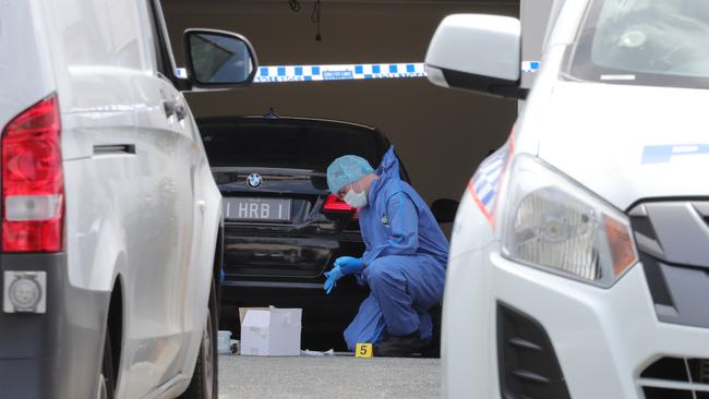 Police at the murder scene in Lachlan St, Pimpama where notorious bikie Shane Bowden was gunned down in his driveway. Police with evidence bags. Picture: Glenn Hampson.