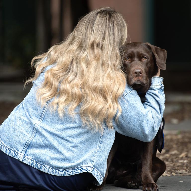 Grace, pictured with court support dog Lucy. Picture: Nicki Connolly/news.com.au