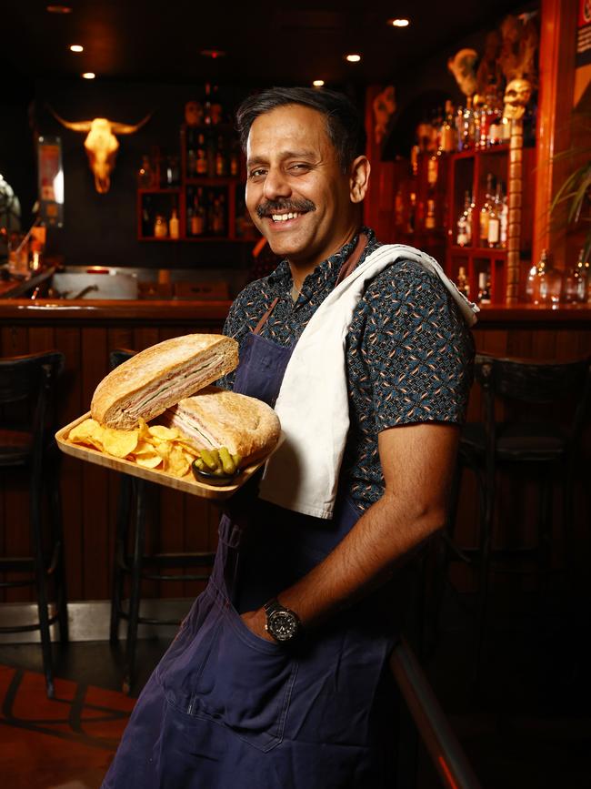At Sydney CBD bar Papa Gedes on Kent Street, owner Micky Dhinse with their famous $60 sandwich, the Muffuleta. Picture: Richard Dobson