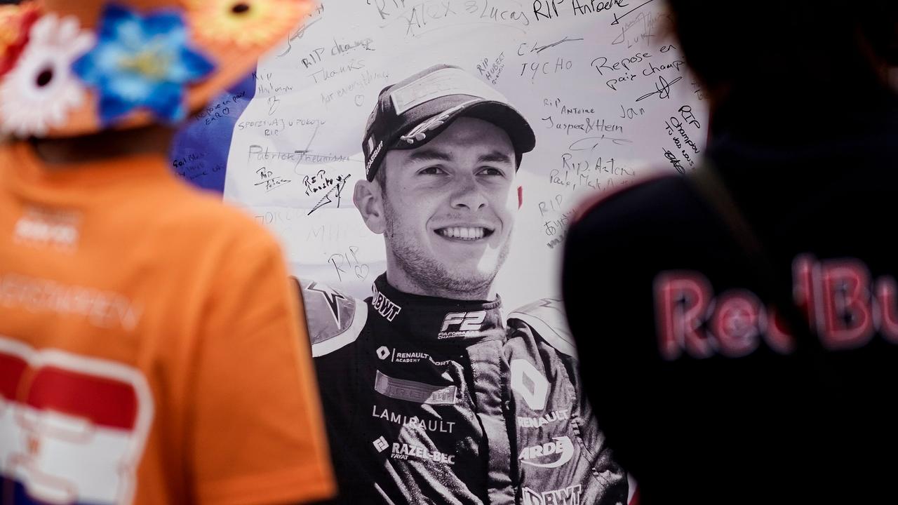 People look at the portrait of Anthoine Hubert covered with condolence messages.