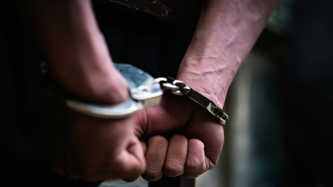 Man on the chair in Handcuffs. - istock