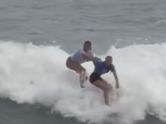 A Portugal surfer (left) tries to push Aussie girl Willoy Hardy (right)  off her board and intimidate her during the world junior surfing event in El Salvador.https://www.instagram.com/p/C6zT1zqvXaZ/