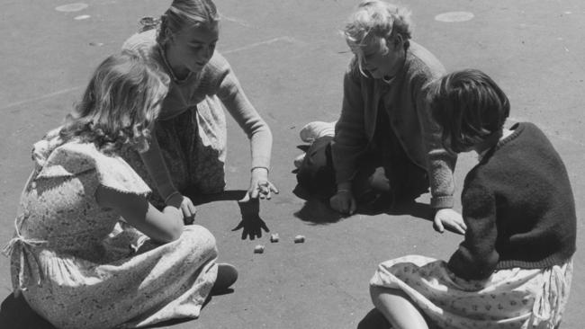 Four girls playing Jacks in Melbourne in 1954.