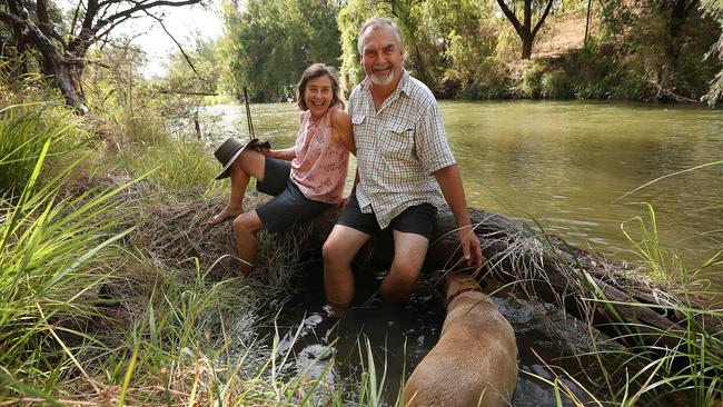 Pine Mountain Nursery manager John Craigie and his wife Gail on the banks of the Brisbane River, which flooded their home in January 2011. Picture: Lyndon Mechielsen