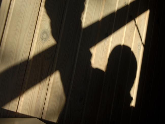 Shadow of a burglar (or murderer or rapist) while he enters through an open window. Picture: Istock