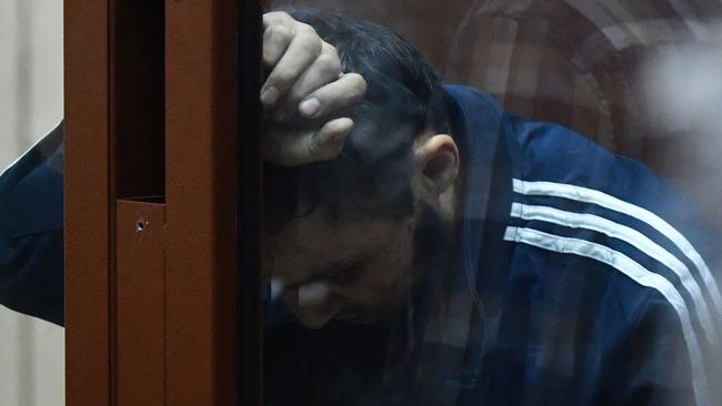 Terror suspect Dalerdjon Barotovich Mirzoyev in the defendant cage as he waits for his pre-trial detention hearing at the Basmanny District Court in Moscow. Picture: AFP.