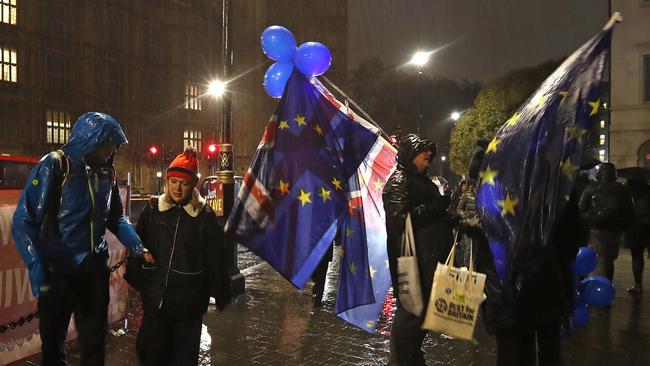 Protesters gather outside parliament as amendments are voted on. Picture: AP.