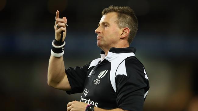 Referee Nigel Owens signals to players.
