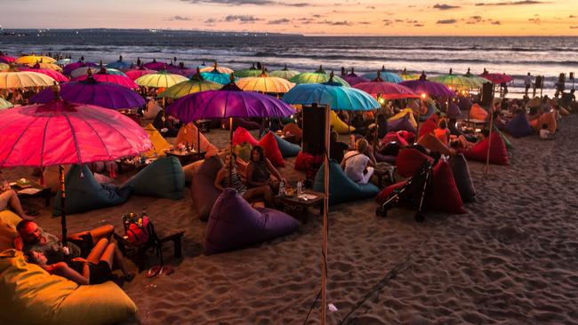 A large crowd of tourists enjoy the sunset at a beach bar on Kuta beach. Picture: Supplied