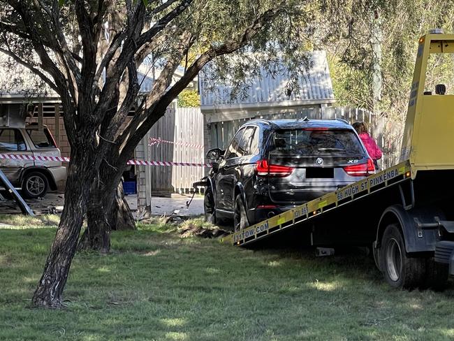 The BMW is removed from the scene. Picture: Matthew Johnston