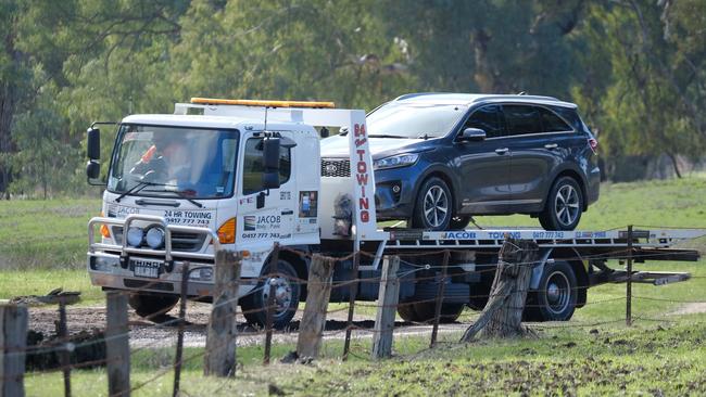 An unmarked police car is towed from the scene. Picture: Simon Dallinger