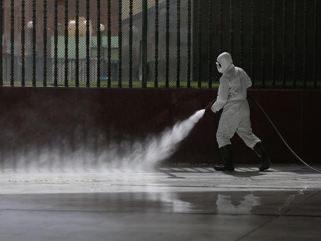 Iraqi workers spraying disinfectant as a precaution against the coronavirus in the shrine of Imam Ali in Najaf, Iraq. Picture: Anmar Khalil