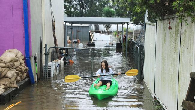 22/3/21: Chloe Panman checks her rabbits at her house at Church street in Windsor which is flooded. John Feder/The Australian