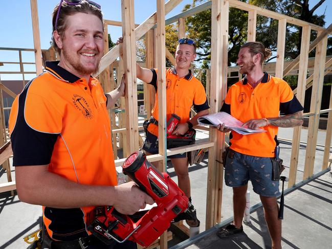 TAFE carpentry apprentices Ethan Sutherland and Karl Van Rijssen with apprentice manager Steve Purcell working on a 54-townhouse development at Richlands. Picture: Tara Croser