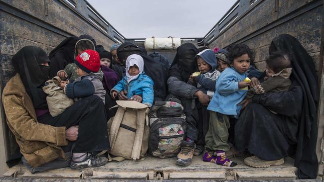 Woman and children who fled the Islamic State group's embattled holdout of Baghouz wait in the back of a truck in the eastern Syrian province of Deir Ezzor. Picture: AFP