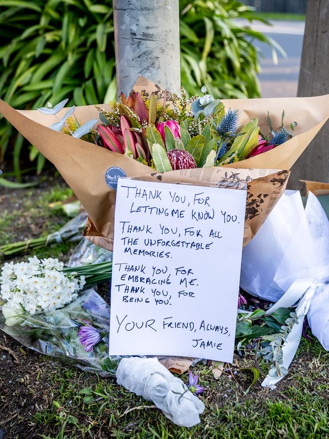 Tributes for Mr Taylor, left at the crash scene in Burwood. Picture: Jake Nowakowski