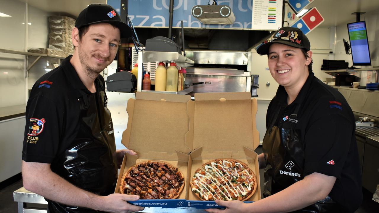 Manager Brad McCartin and the fastest pizza cutter in Australia and New Zealand, Jessie Hoger, from Domino's Gympie. Photo: Kristen Camp