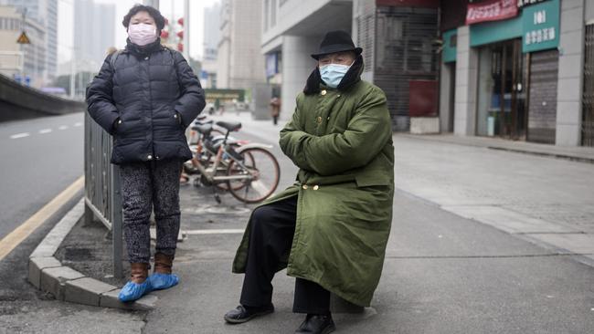 Two residents wear protective masks in Wuhan, China, as the city remained in lockdown. Picture: Getty Images