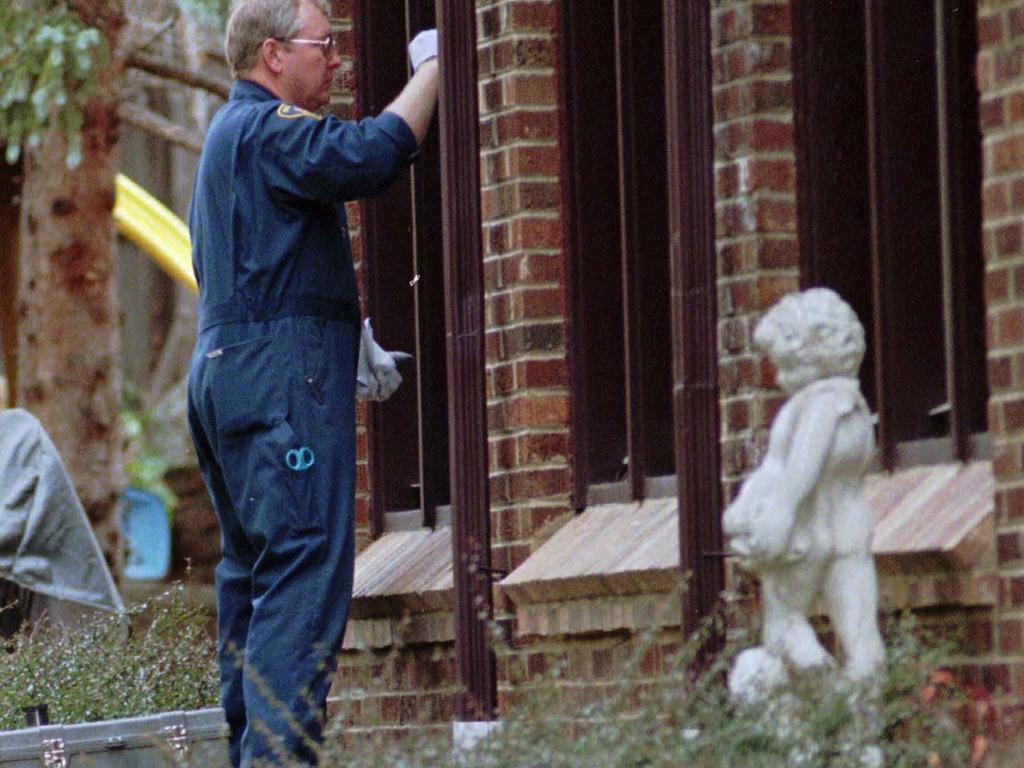 An investigator dusts a window of the Ramsey home for fingerprints on December 30, 1996. Picture: AP Photo/David Zalubowski 