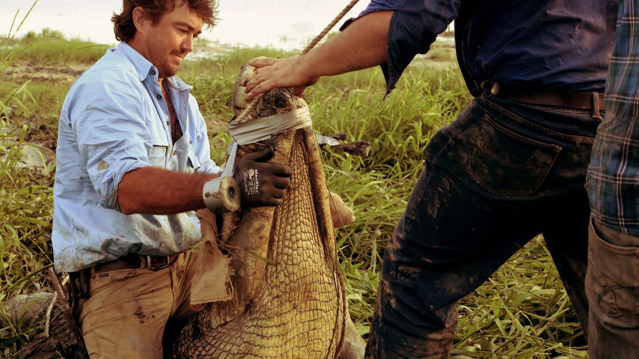 Wright helps to restrain a crocodile. Picture: National Geographic/Foxtel