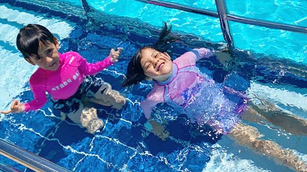 Siblings Santiago and Yindi Cooper, 8, enjoying the water at the Ballina Memorial Swimming Pool &amp; Waterslide in October 2020. Photo: Javier Encalada