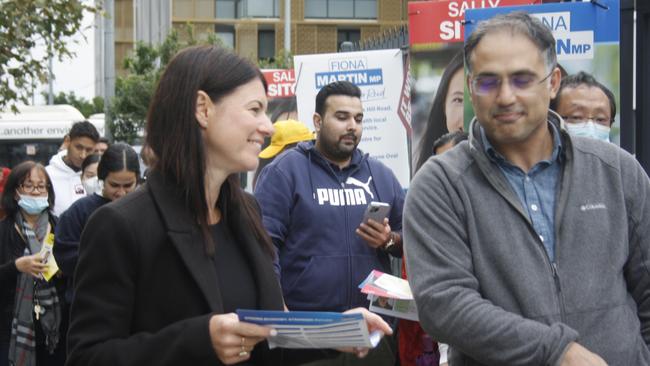 Fiona Martin dispenses pamphlets at Wentworth Point Public School on polling day. Picture: Alexi Demetriadi