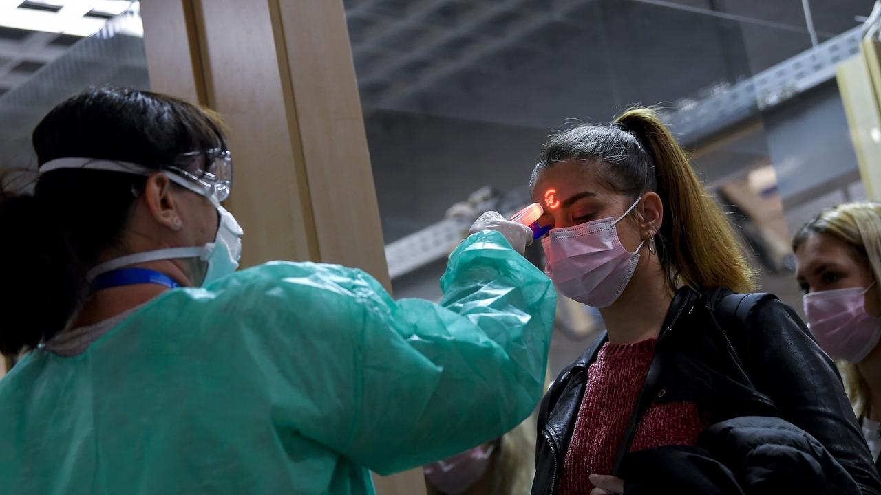 Airport staff have been checking the temperatures of passengers returning from virus-hit areas. Picture: AP/Zsolt CzeglÃ/MTI