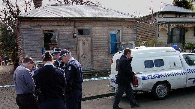 Police officers inspect the house where baby Montana Barbaro was found.