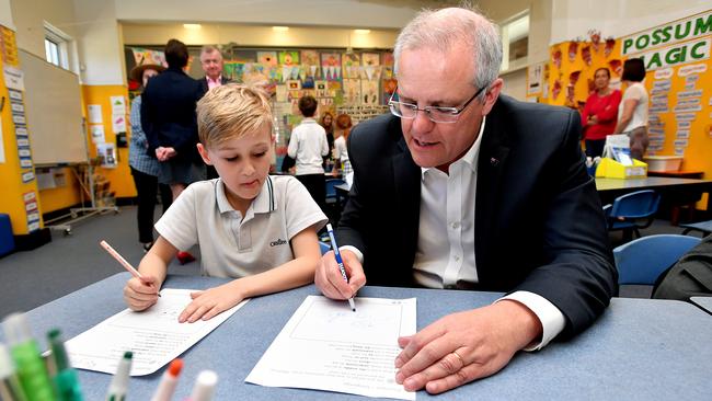 Prime Minister Scott Morrison interacts with a student during a visit to Galilee Catholic Primary School in Sydney in 2018.