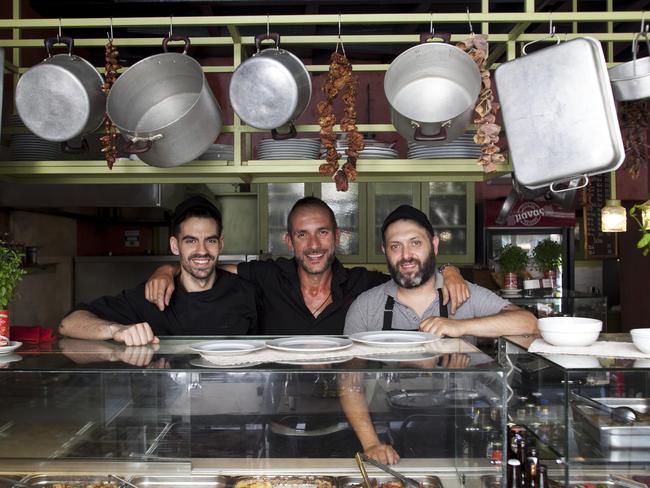 Staying positive ... Mama's Kitchen restaurant manager Bill Grigoratus (centre) with co-workers. Picture: Angelos Giotopoulos