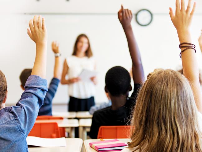 School kids in classroom. Generic (stock) photo of children in a classroom with teacher in background.Picture: iStock