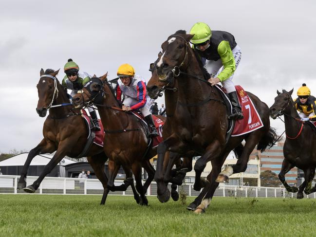 MELBOURNE, AUSTRALIA - OCTOBER 16: Brett Prebble riding Incentivise (L) in to the first turn before winning Race 9, the Carlton Draught Caulfield Cup, during Caulfield Cup Day at Caulfield Racecourse on October 16, 2021 in Melbourne, Australia. (Photo by Vince Caligiuri/Getty Images)